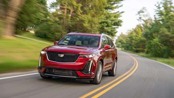 An exterior shot of a red 2020 XT Model driving on the road