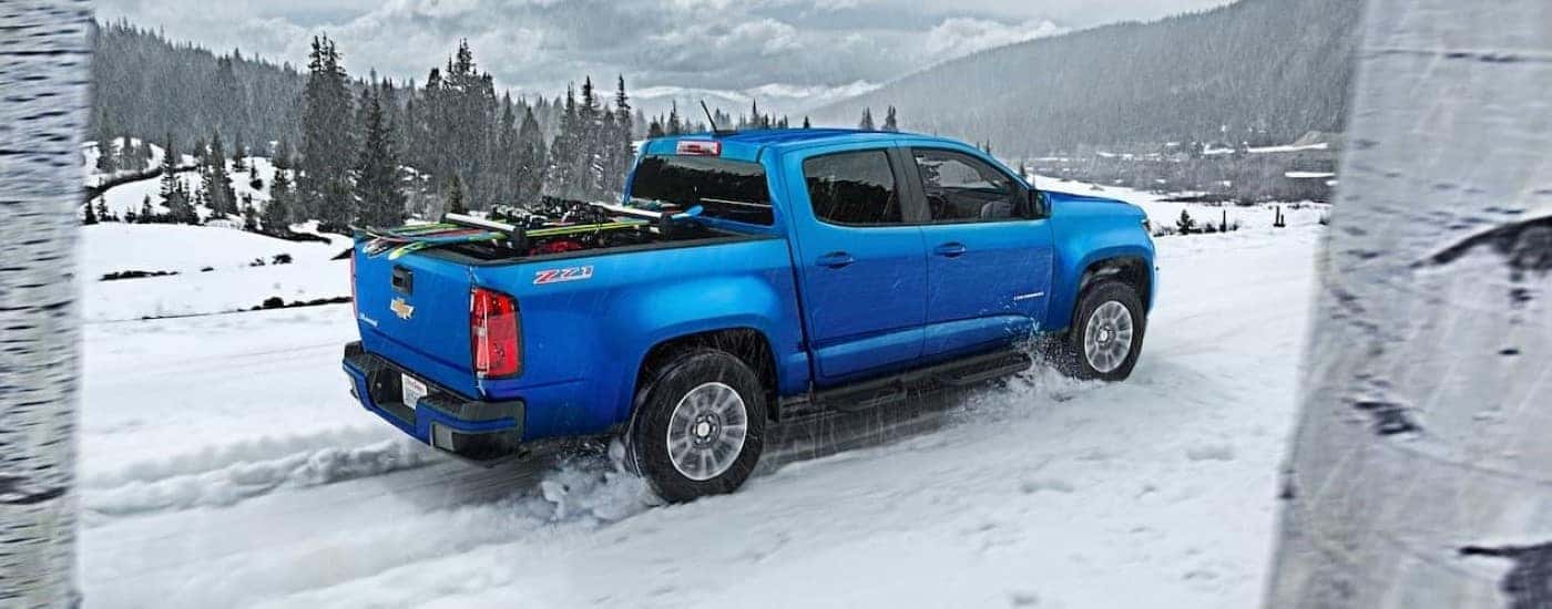 A blue 2019 Chevy Colorado Z71 is shown on a snowy path after leaving a Chevy dealer.