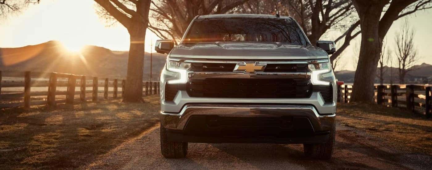Front angle view of a grey 2024 Chevy Silverado 1500 driving from a Chevy dealer near Crawfordsville.