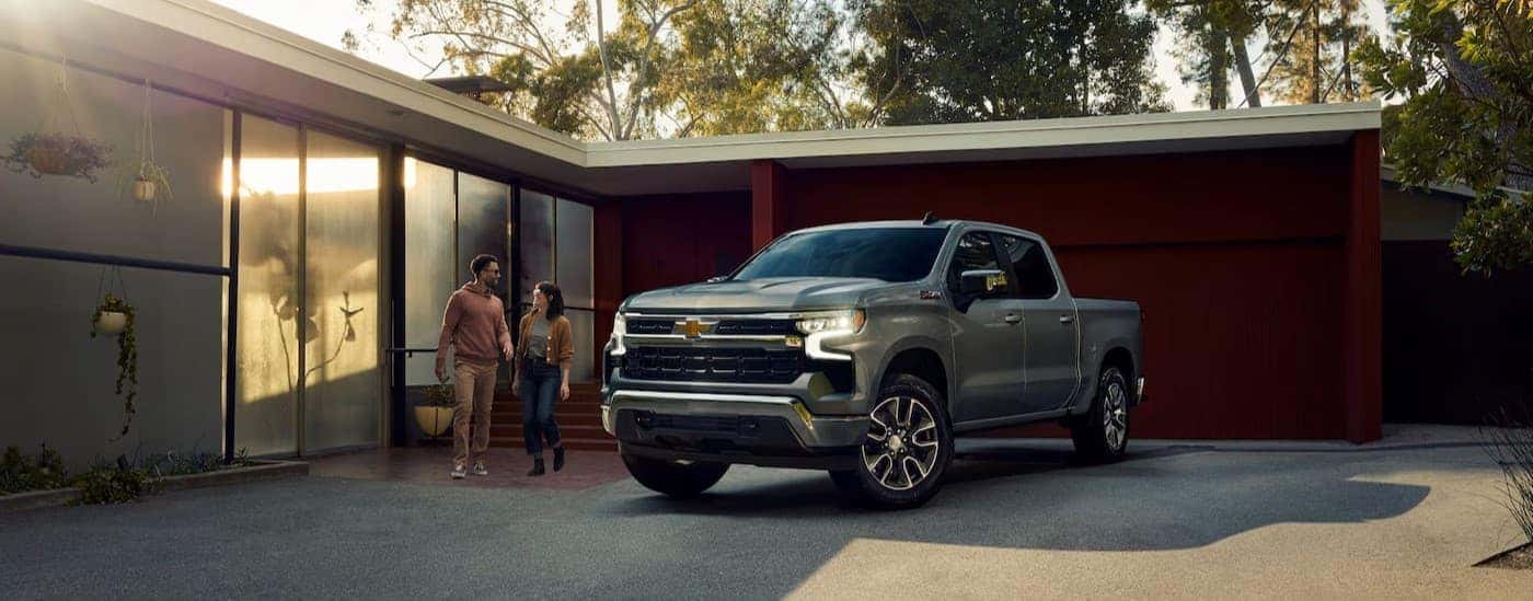 A silver 2025 Chevy Silverado Z71 is shown parked near a house.