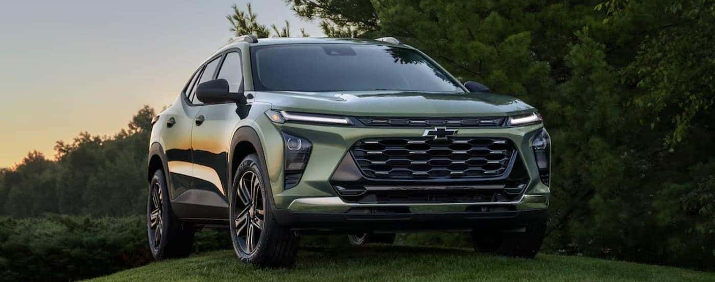 A green 2025 Chevy Trax ACTIV is shown parked on a hill.