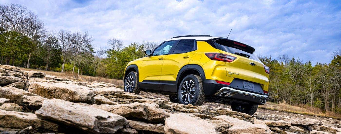A yellow 2024 Chevy Trailblazer ACTIV is shown from the rear at an angle.