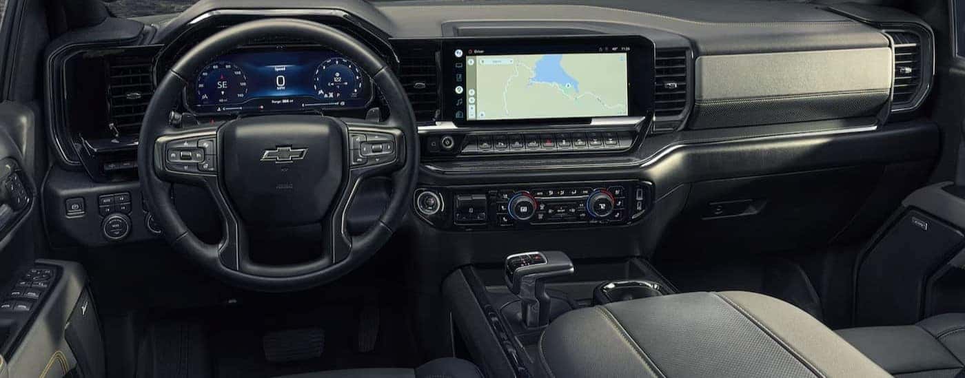The black interior and dash are shown in a 2025 Chevy Silverado for sale.