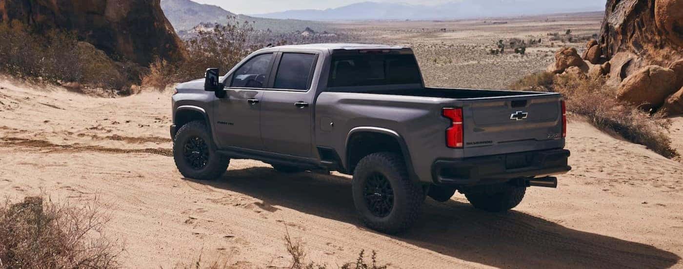 A gray 2025 Chevy Silverado 2500 ZR2 is shown parked off-road.