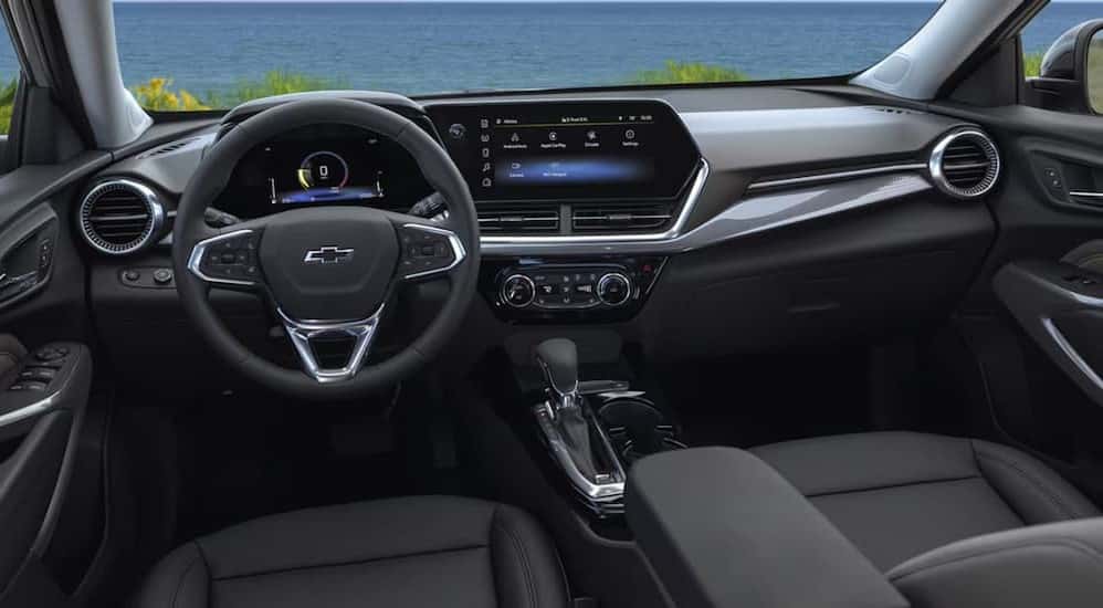 The black interior and dash are shown in a 2025 Chevy Trax.