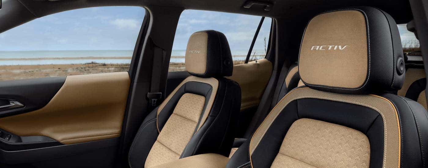 The black and tan interior of a 2025 Chevy Equinox ACTIV.