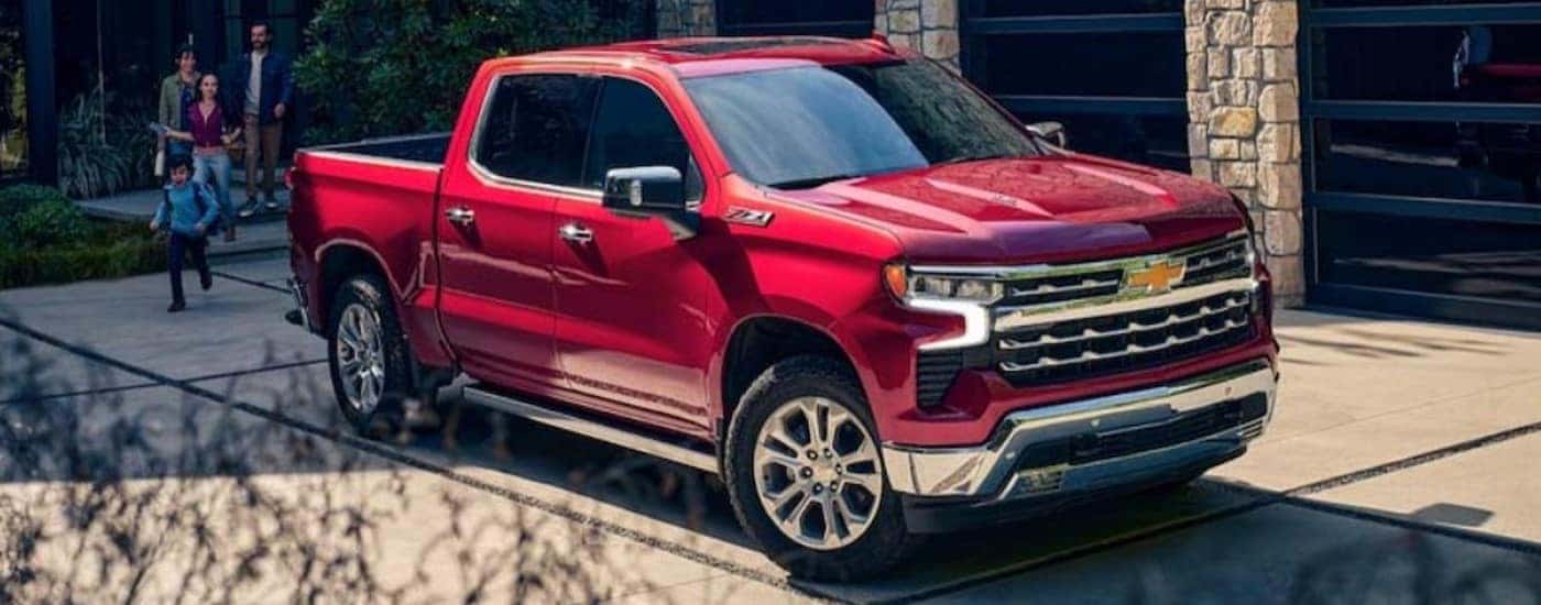 A red 2024 Chevy Silverado 1500 Z71 parked on a driveway.