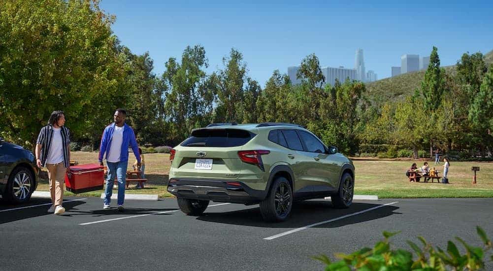 A green 2025 Chevy Trax ACTIV parked on a sunny day.