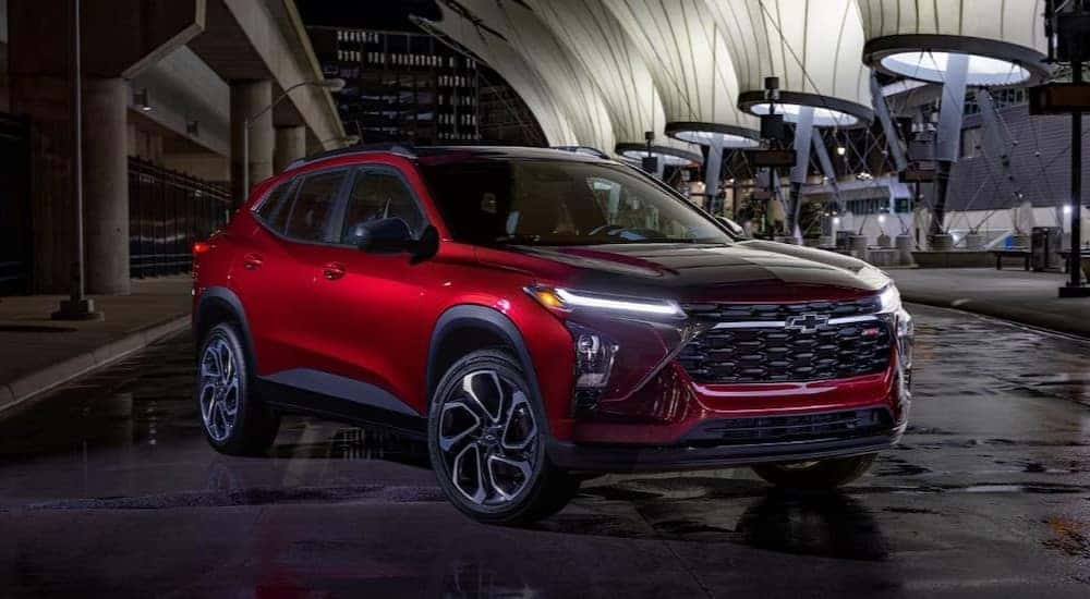 A red 2025 Chevy Trax RS parked at night.