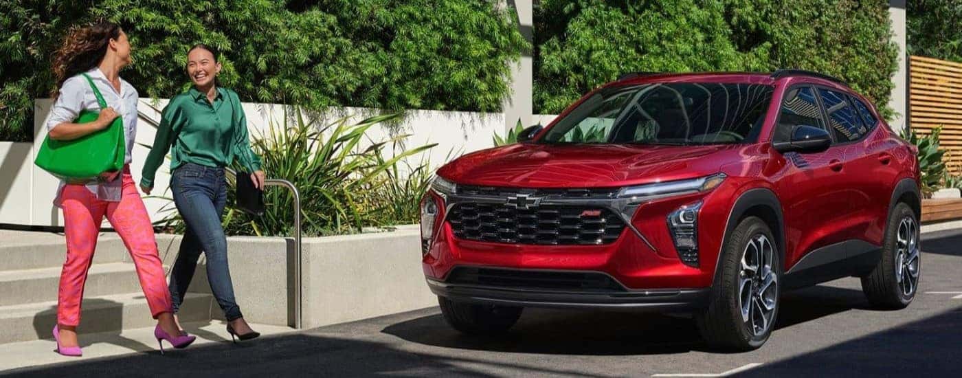 A red 2024 Chevy Trax RS is shown parked after visiting a Chevy dealer near Cayuga.
