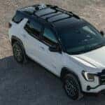 A white 2025 GMC Terrain AT4 parked at a GMC dealer near Champaign.