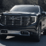 Black 2026 GMC Sierra 1500 for sale near Champaign rounding a corner on a test drive