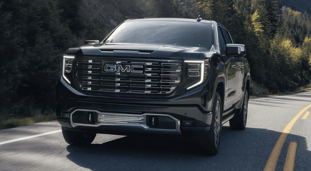 Black 2026 GMC Sierra 1500 for sale near Champaign rounding a corner on a test drive