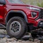 Close-up of the front wheel on a red 2026 GMC Canyon AT4X.