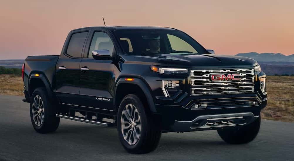 A black2026 GMC Canyon Denali parked on a backroad.