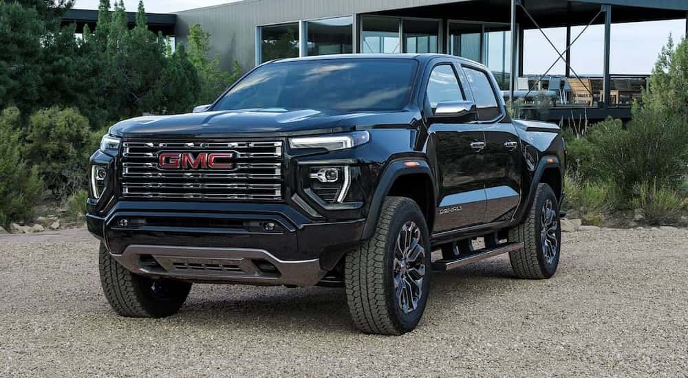 A black 2026 GMC Canyon Denali parked in a driveway.