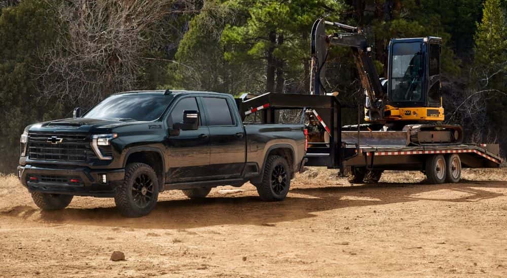 2026 Chevy Silverado 2500 HD towing an excavator