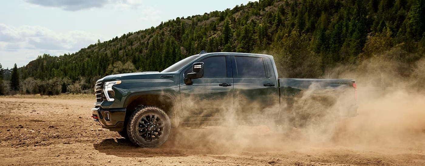 A gray 2026 Chevy Silverado 2500 for sale near Champaign off-roading.