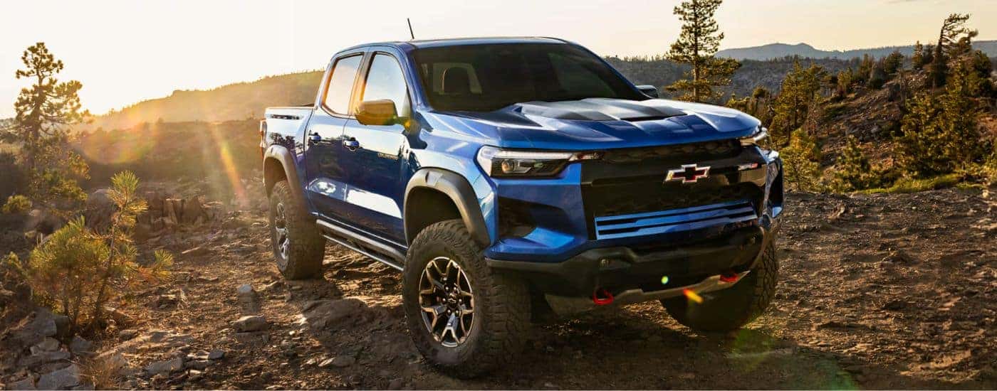 A blue 2026 Chevy Colorado parked on a rocky mountain.