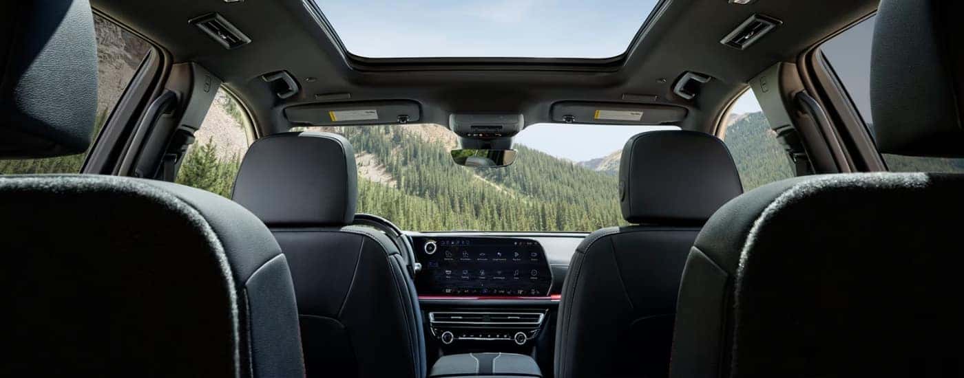 2026 Chevy Traverse black interior from the back with open moonroof.
