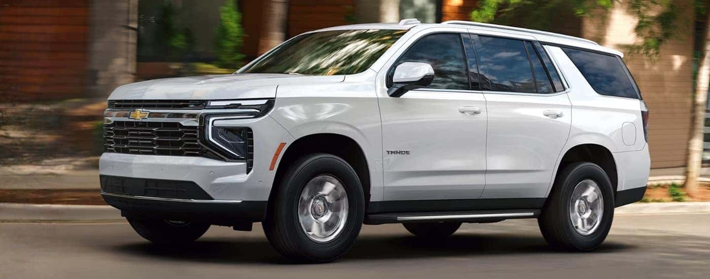 White 2026 Chevy Tahoe driving through a city