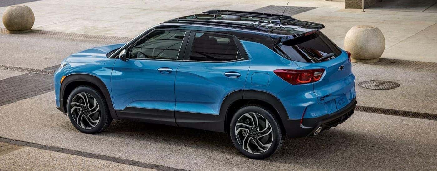 A blue 2025 Chevy Trailblazer parked near a dealership.