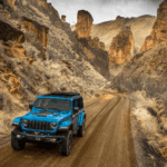 2025 Jeep Wrangler in on a dirt terrain in the day time