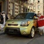Kia parked on street with large hamsters from commercial