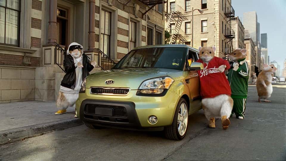 Kia parked on street with large hamsters from commercial