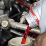 transmission (CVT) fluid being poured in