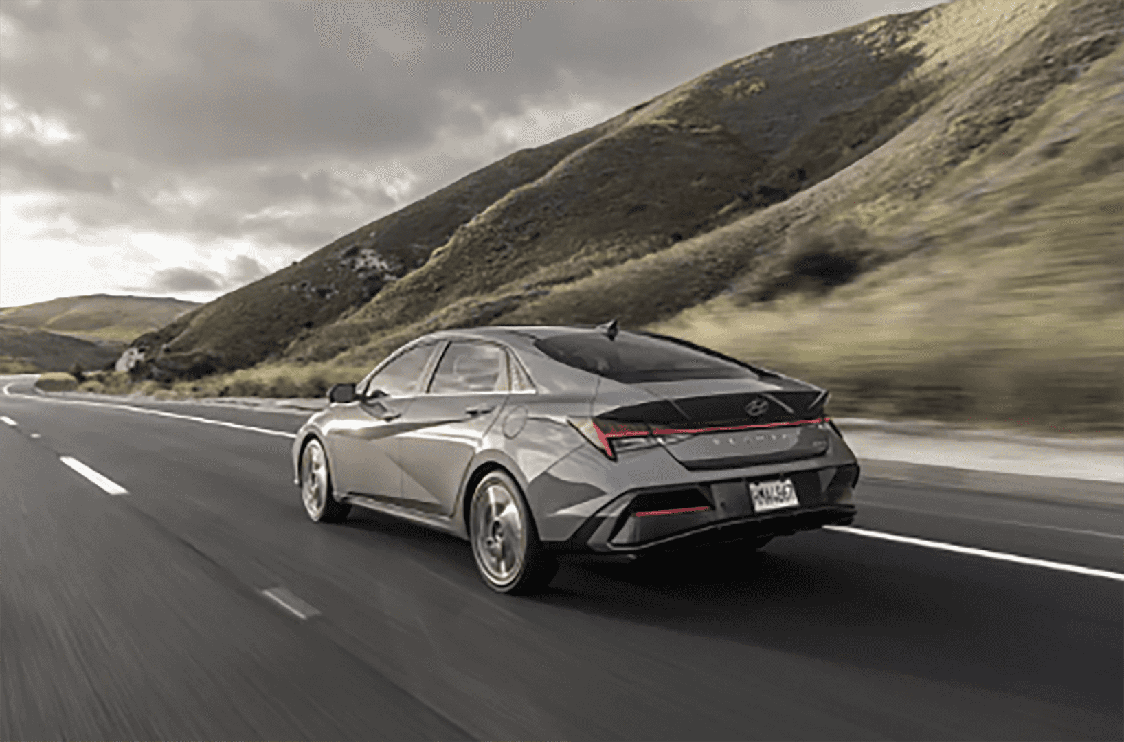 2026_Hyundai_Elantra_dark_gray_on_the_road_back_view